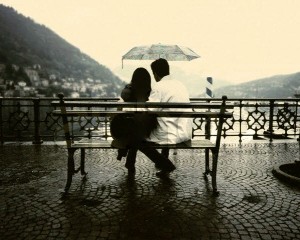 Couple Sitting on a Bench in the Rain
